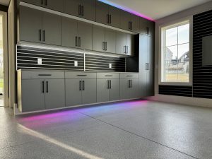 Custom Schist Garage Flooring with Custom Garage Cabinets and Lighting